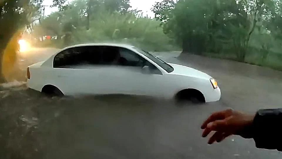 Body-Cam Shows Dramatic Rescue Of Baby From Car Swept By Floodwaters In Beeville, Texas
