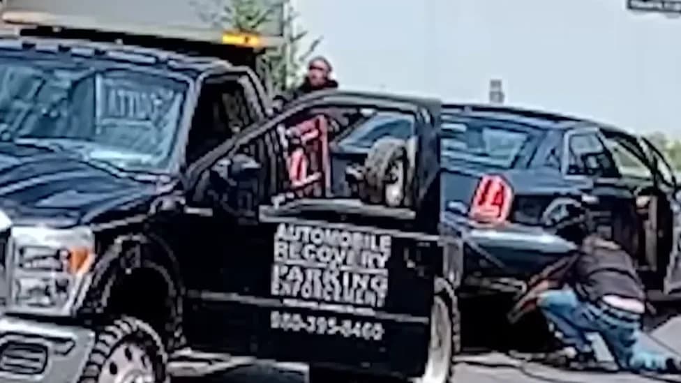 Tow-Truck Driver Arrested After Video Shows Alleged Dragging Of Occupied Car And Pepper-Spray Incident