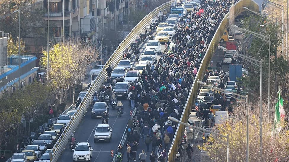 Iran Publicly Hangs Two Men After January Protests; Crowd Shouts 'Dishonorable' As Security Fires Tear Gas