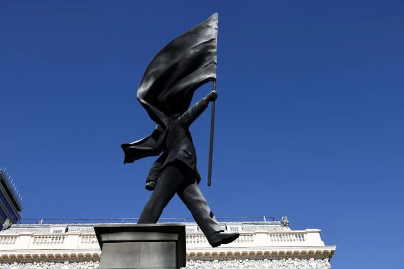 Banksy Erects Statue Of Flag-Obscured Man On Plinth Near London’s Mall